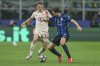 Bayern's Josip Stanisic, left, challenges for the ball with Inter Milan's Matteo Darmian during the Champions League quarterfinal second leg soccer match between Inter Milan and Bayern Munich at the San Siro stadium in Milan, Italy, Wednesday, April 16, 2025. (AP Photo/Antonio Calanni)