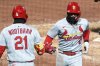 St. Louis Cardinals' Masyn Winn (0) celebrates with teammate Lars Nootbaar as he returns to the dugout after hitting a solo home run off Pittsburgh Pirates pitcher Thomas Harrington during the ninth inning of a baseball game in Pittsburgh, Monday, April 7, 2025. (AP Photo/Gene J. Puskar)