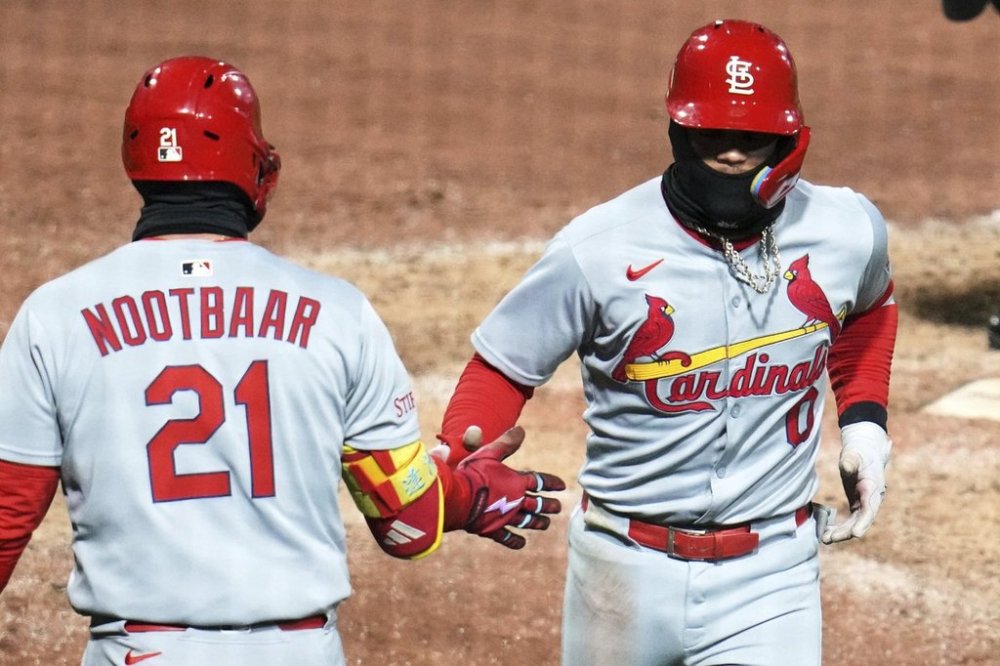 St. Louis Cardinals' Masyn Winn (0) celebrates with teammate Lars Nootbaar as he returns to the dugout after hitting a solo home run off Pittsburgh Pirates pitcher Thomas Harrington during the ninth inning of a baseball game in Pittsburgh, Monday, April 7, 2025. (AP Photo/Gene J. Puskar)