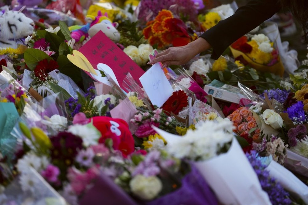 A card is placed at a memorial for the Lapu Lapu Day block party tragedy in Vancouver, B.C., on Sunday, April 27, 2025. Shock and grief rippled through Canada's Filipino community on Sunday as members struggled to come to grips with an attack at a cultural street festival in Vancouver on Saturday that killed 11 people and injured dozens more. THE CANADIAN PRESS/Sean Kilpatrick