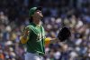 Athletics pitcher J.T. Ginn (70) looks to the sky as he leaves the mound during the sixth inning of a baseball game against the New York Mets Saturday, April 12, 2025, in West Sacramento, Calif. (AP Photo/Sara Nevis)