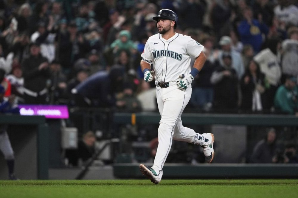 Seattle Mariners' Cal Raleigh jogs home after hitting a solo home run against the Texas Rangers during the fifth inning of a baseball game Saturday, April 12, 2025, in Seattle. (AP Photo/Lindsey Wasson)