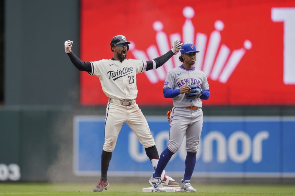 Minnesota Twins' Byron Buxton (25), left, celebrates next to New York Mets shortstop Francisco Lindor (12) after hitting an RBI-single during the fifth inning of a baseball game, Wednesday, April 16, 2025, in Minneapolis. (AP Photo/Abbie Parr)