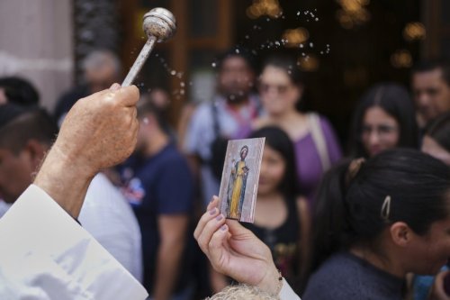 A priest sprinkles 