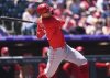 Cincinnati Reds' Austin Hays grounds out but drives in a run off Colorado Rockies starting pitcher Bradley Blalock in the first inning of a baseball game Sunday, April 27, 2025, in Denver. (AP Photo/David Zalubowski)