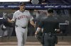 Boston Red Sox manager Alex Cora talks to home plate umpire Mike Muchlinski after a foul ball by Trevor Story off Tampa Bay Rays pitcher Shane Baz during the fourth inning of a baseball game Monday, April 14, 2025, in Tampa, Fla. (AP Photo/Chris O'Meara)