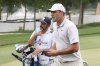 Scottie Scheffler, right, walks on the 18th fairway during the first round of the CJ Cup Byron Nelson golf tournament in McKinney, Texas, Thursday, May 1, 2025. (AP Photo/Gareth Patterson)