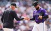 Colorado Rockies manager Bud Black, left, takes the ball from relief pitcher Tyler Kinley as he is pulled form the mound after giving up an RBI single to Cincinnati Reds' Spencer Steer in the ninth inning of a baseball game Saturday, April 26, 2025, in Denver. (AP Photo/David Zalubowski)