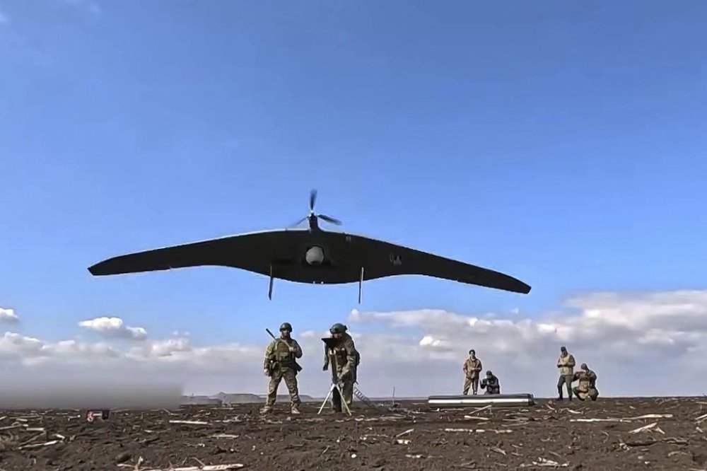 In this photo taken from video distributed by Russian Defense Ministry Press Service on Friday, April 18, 2025, Russian soldiers launch a Supercam intelligence unmanned aerial vehicle towards Ukrainian positions in Ukraine. (Russian Defense Ministry Press Service via AP)
