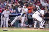 San Francisco Giants' Matt Chapman, left, slides in the score on the single by Casey Schmitt as Philadelphia Phillies catcher J.T. Realmuto, right, waits for the ball during the sixth inning of a baseball game, Tuesday, April 15, 2025, in Philadelphia. (AP Photo/Chris Szagola)