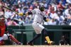 Cleveland Guardians' Carlos Santana follows through for a three-run double during the sixth inning of a baseball game against the Washington Nationals, Wednesday, May 7, 2025, in Washington. (AP Photo/Nick Wass)