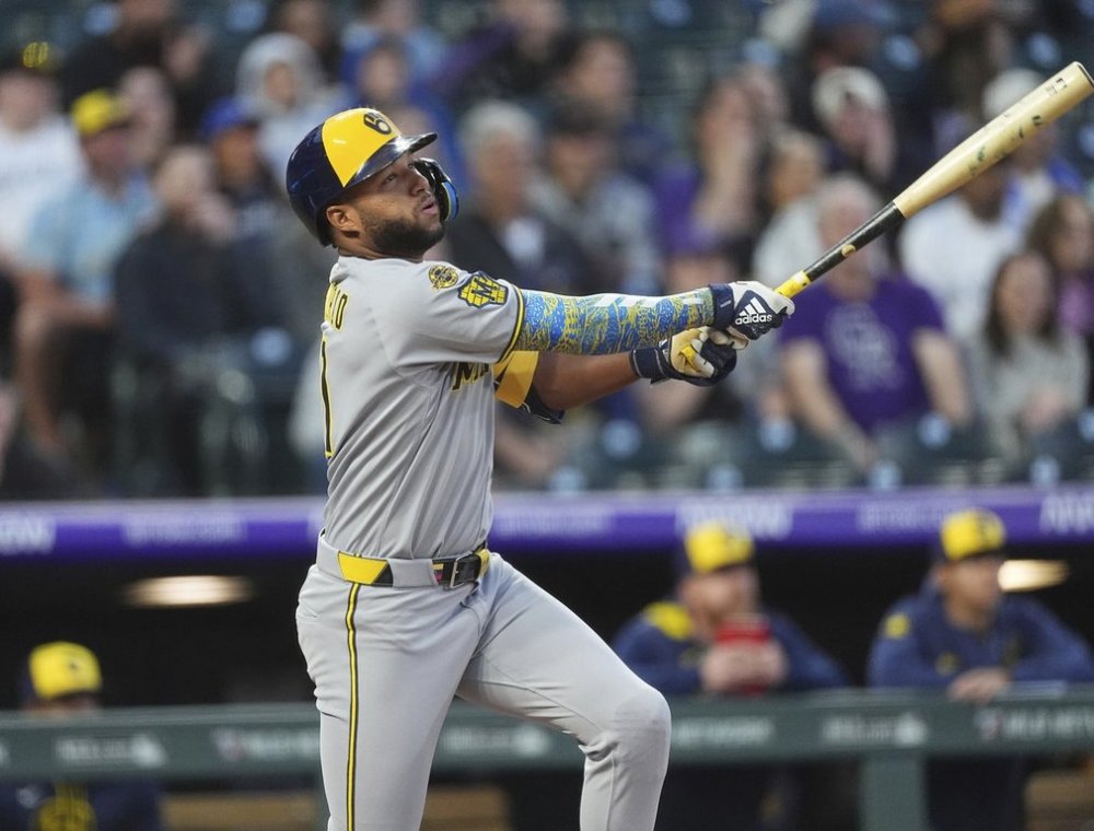 Milwaukee Brewers' Jackson Chourio follows the flight of his double to drive in two runs against Colorado Rockies starting pitcher Antonio Senzatela in the third inning of a baseball game Wednesday, April 9, 2025, in Denver. (AP Photo/David Zalubowski)