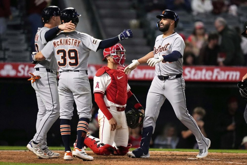 Detroit Tigers' Riley Greene, right, is congratulated by Spencer Torkelson, left, and Zach McKinstry, second from left, after hitting a three-run home run as Los Angeles Angels catcher Logan O'Hoppe kneels at the plate during the ninth inning of a baseball game against the Los Angeles Angels, Friday, May 2, 2025, in Anaheim, Calif. (AP Photo/Mark J. Terrill)