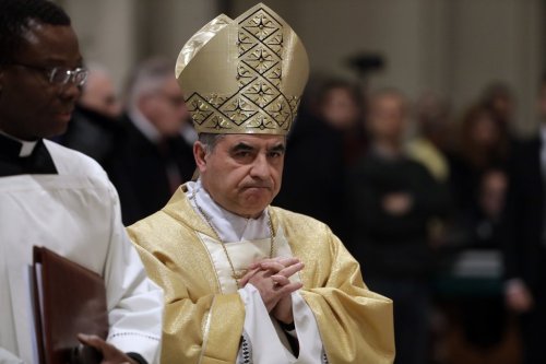 FILE - Mons. Angelo Becciu presides over an eucharistic liturgy, at the St. John in Latheran Basilica, in Rome, Feb. 9, 2017. (AP Photo/Gregorio Borgia, File )