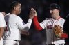 Boston Red Sox third base Alex Bregman, right, celebrates with Rafael Devers, left, after defeating the Minnesota Twins in a baseball game at Fenway Park, Friday, May 2, 2025, in Boston. (AP Photo/Charles Krupa)
