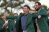 Scottie Scheffler puts the green Jacket on winner, Rory McIlroy, of Northern Ireland, at the Masters golf tournament, Sunday, April 13, 2025, in Augusta, Ga. (AP Photo/Ashley Landis)