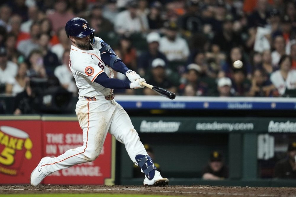 Houston Astros' Christian Walker (8) hits a home run during the sixth inning of a baseball game against the San Diego Padres in Houston, Saturday, April 19, 2025. Isaac Paredes also scored. (AP Photo/Ashley Landis)