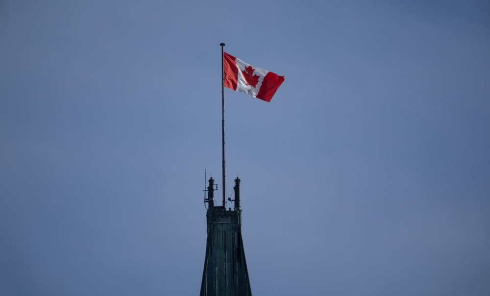 The Canadian flag flies over the Peace Tower on Parliament Hill, Friday, Feb. 14, 2025 in Ottawa. THE CANADIAN PRESS/Adrian Wyld