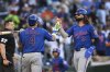New York Mets' Jesse Winker (3) is greeted by Francisco Alvarez (4) after scoring on a double hit by Brandon Nimmo off Washington Nationals pitcher Eduardo Salazar during the eighth inning of a baseball game in Washington, Monday, April 28, 2025. (AP Photo/Terrance Williams)