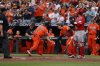 Baltimore Orioles' Gunnar Henderson, left, high fives teammate Adley Rutschman, right, after hitting a home run in the first inning of a baseball game against the Cincinnati Reds, Saturday, April 19, 2025, in Baltimore. (AP Photo/Alyssa Howell)