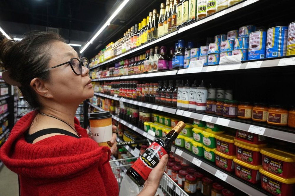 Chef and Food Stylist Miki Fujiwara shops China's Pearl River soy sauce at 99 Ranch Market, an Asian grocery store in Los Angeles Monday, April 7, 2025. (AP Photo/Damian Dovarganes)