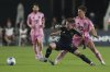 Vancouver Whitecaps defender Tate Johnson (28) goes for the ball against Inter Miami forward Tadeo Allende, right, during the first half of a CONCACAF Champions Cup second-leg semifinal soccer match, Wednesday, April 30, 2025, in Fort Lauderdale, Fla. (AP Photo/Lynne Sladky)