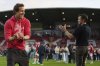 Wrexham co-owners Ryan Reynolds, left, and Rob McElhenney celebrate at the end of the English League One soccer match between Wrexham and Charlton Athletic at the Racecourse ground in Wrexham, Wales, Saturday, April 26, 2025. (AP Photo/Jon Super)