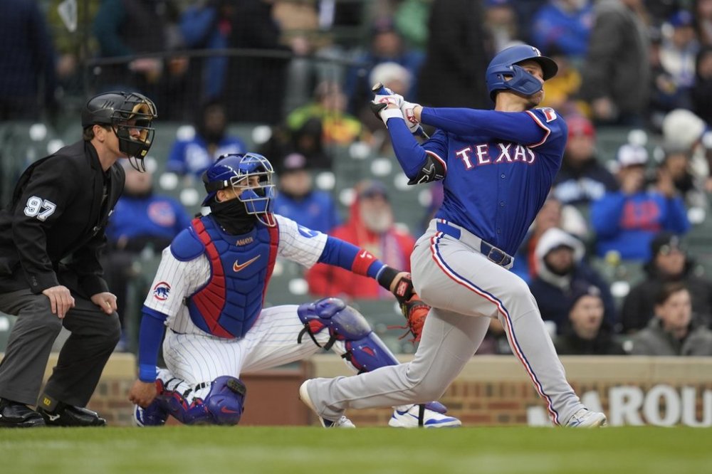 Texas Rangers Corey Seager (5) hits a home run during the first inning of a baseball game against the Chicago Cubs, Wednesday, April 9, 2025, in Chicago. (AP Photo/Erin Hooley)