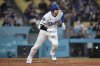 Los Angeles Dodgers' Shohei Ohtani runs to first as he grounds out during the eighth inning of a baseball game against the Colorado Rockies, Wednesday, April 16, 2025, in Los Angeles. (AP Photo/Mark J. Terrill)