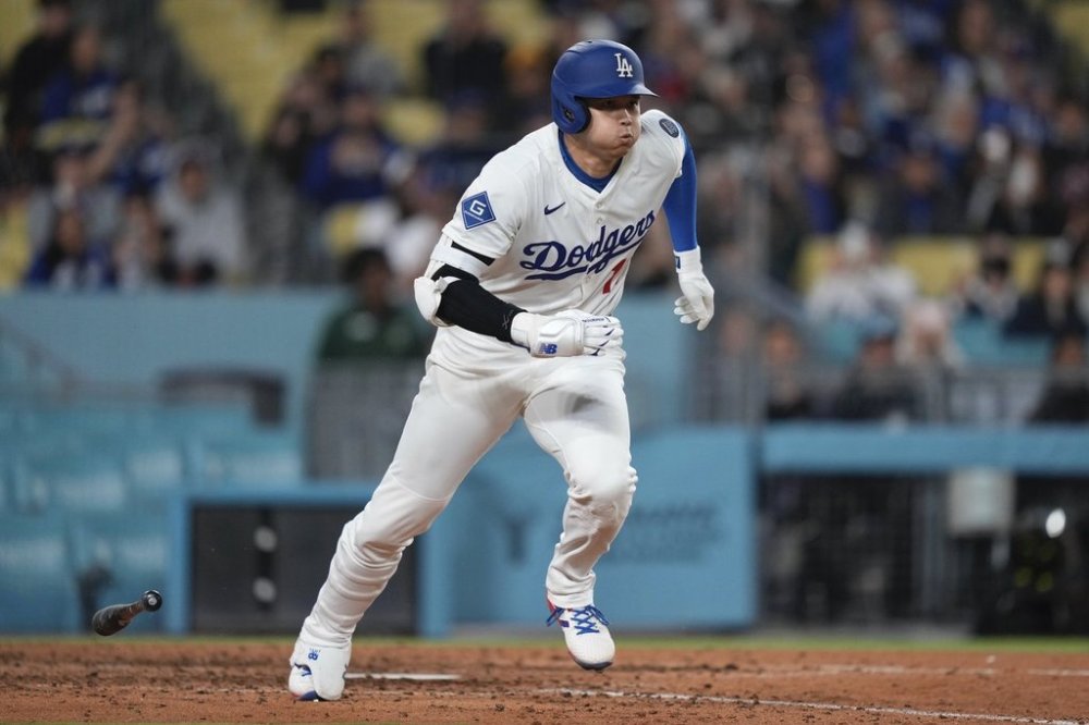 Los Angeles Dodgers' Shohei Ohtani runs to first as he grounds out during the eighth inning of a baseball game against the Colorado Rockies, Wednesday, April 16, 2025, in Los Angeles. (AP Photo/Mark J. Terrill)