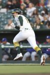 Athletics Nick Kurtz runs to first for his first career major league hit against the Texas Rangers during the first inning of a baseball game, Wednesday, April 23, 2025, in West Sacramento, Calif. (AP Photo/Scott Marshall)
