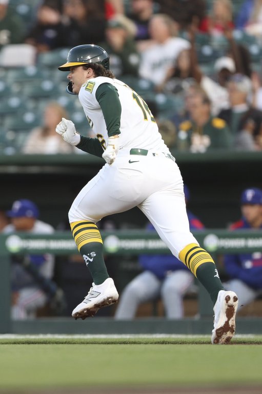 Athletics Nick Kurtz runs to first for his first career major league hit against the Texas Rangers during the first inning of a baseball game, Wednesday, April 23, 2025, in West Sacramento, Calif. (AP Photo/Scott Marshall)