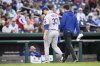New York Mets relief pitcher A.J. Minter (33) leaves a baseball game with a trainer during the eighth inning against the Washington Nationals, Saturday, April 26, 2025, in Washington. (AP Photo/Nick Wass)