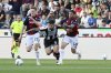 Udinese's Martin Payero, center, fights for the ball with Bologna's Davide Calabria, right, and Michel Aebischer, during the Serie A soccer match between Udinese and Bologna at the Bluenergy Stadium in Udine, Italy, Monday, April 28, 2025. (Andrea Bressanutti/LaPresse via AP)