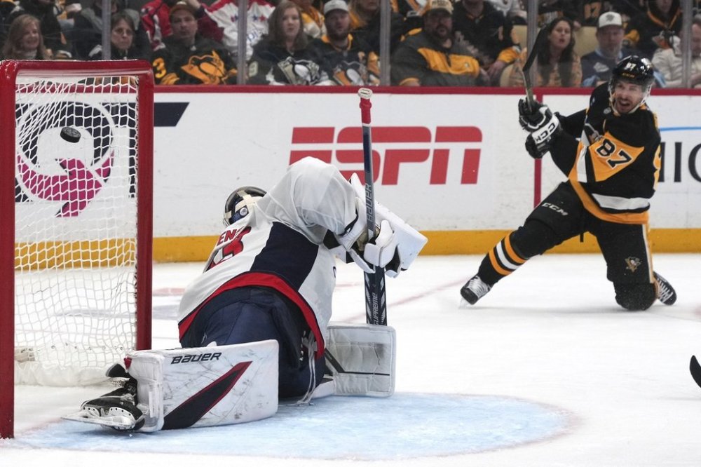Pittsburgh Penguins' Sidney Crosby (87) get a shot past Washington Capitals goaltender Clay Stevenson, left, for a goal during the second period of an NHL hockey game in Pittsburgh, Thursday, April 17, 2025. (AP Photo/Gene J. Puskar)