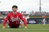 Cincinnati Reds' Austin Hays (12) stretches prior to a spring training baseball game against the Cleveland Guardians, Monday, March 17, 2025, in Goodyear, Ariz. (AP Photo/Ross D. Franklin)
