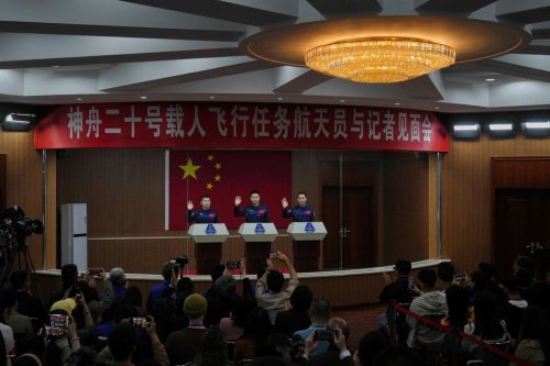 Chinese astronauts for the upcoming Shenzhou 20 mission from left, Wang Jie, captain Chen Dong and Chen Zhongrui wave as they meet with the press at the Jiuquan Satellite Launch Center in northwest China, Wednesday, April 23, 2025. (AP Photo/Andy Wong)