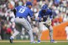 Kansas City Royals' Salvador Perez (13) and Bobby Witt Jr. celebrate after the final out against the Detroit Tigers in the tenth inning during a baseball game, Sunday, April 20, 2025, in Detroit. (AP Photo/Paul Sancya)