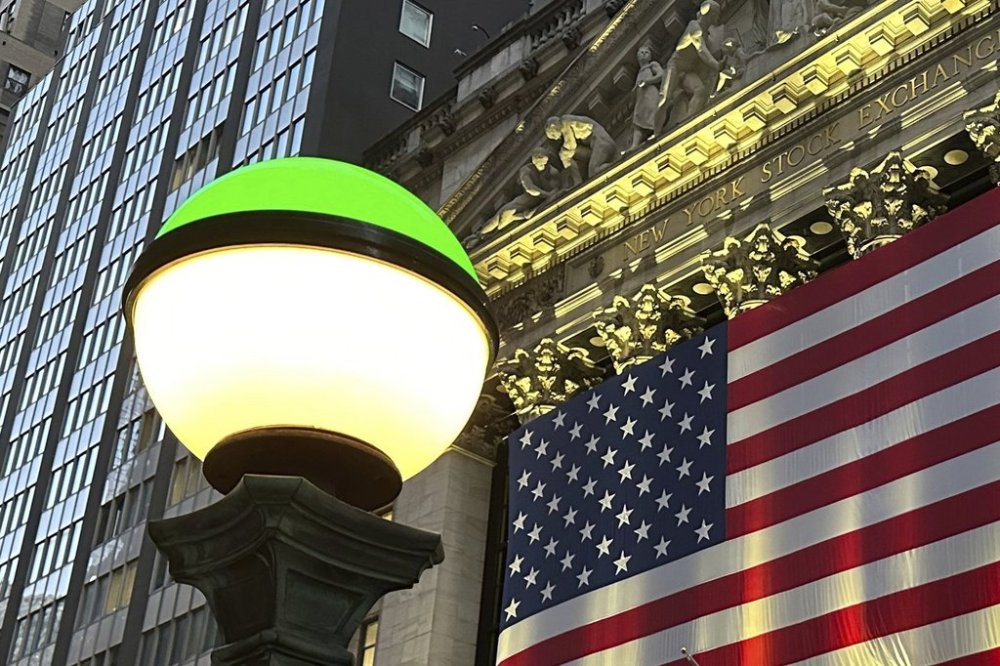 FILE - The American flags hangs on the facade of the New York Stock Exchange in New York's Financial District on Tuesday, Nov. 5, 2024. (AP Photo/Peter Morgan, File)