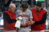 Cincinnati Reds outfielder Tyler Callihan (32) is helped off the field after colliding with the wall during the third inning of a baseball game against the Atlanta Braves, Monday, May 5, 2025, in Atlanta. (AP Photo/Butch Dill)