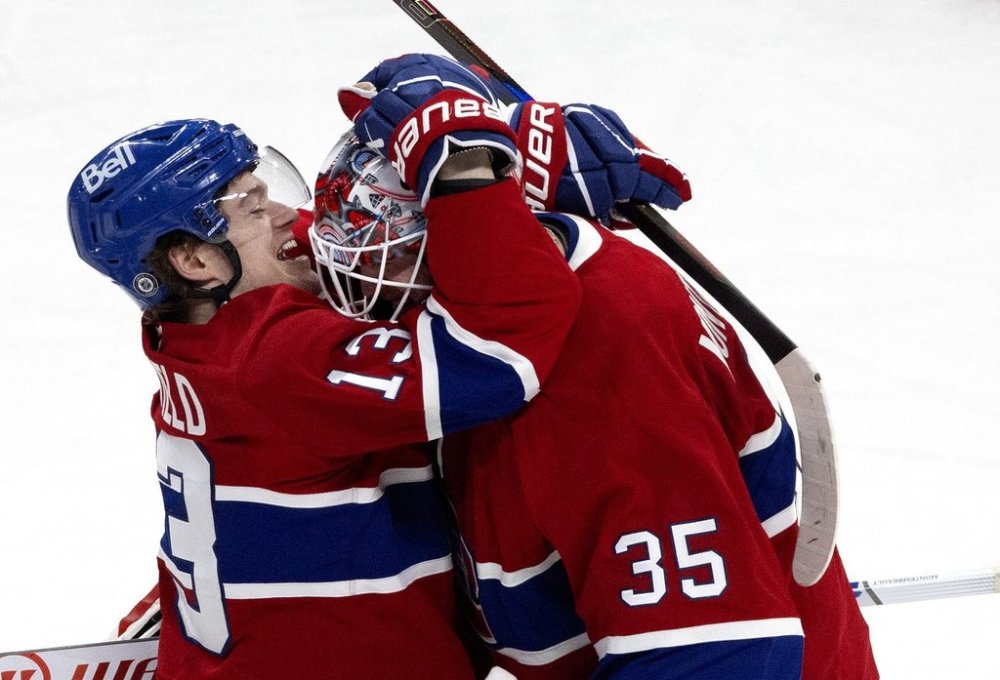Montreal Canadiens' Cole Caufield (13) celebrates with goaltender Sam Montembeault (35) after defeating the Carolina Hurricanes in NHL hockey action in Montreal on Wednesday, April 16, 2025. THE CANADIAN PRESS/Allen McInnis