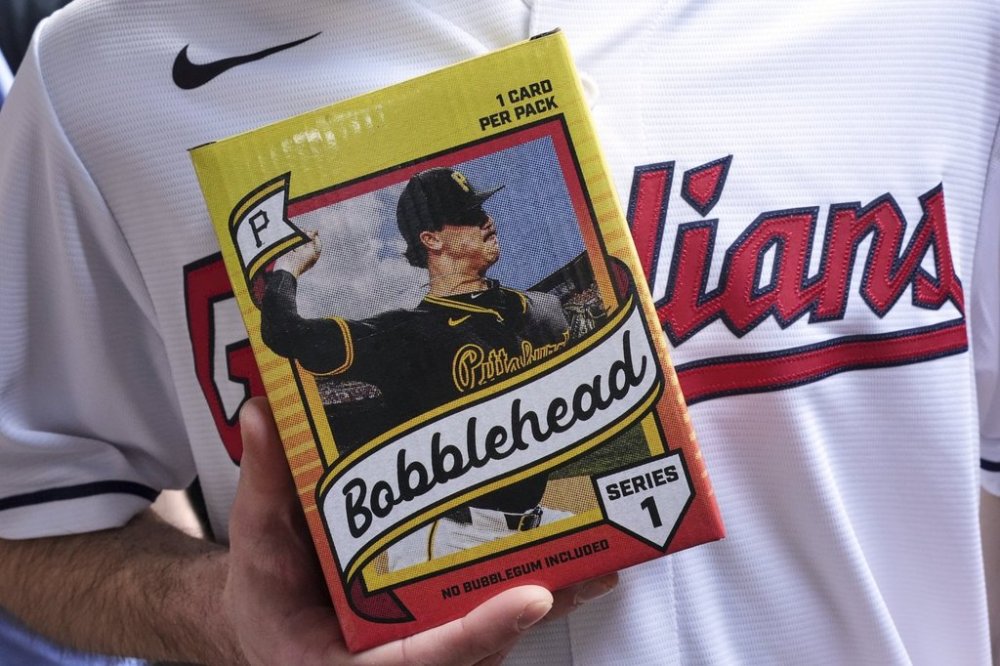 Cleveland Guardians fan Andy Lewis of Elyria, Ohio, holds his Pittsburgh Pirates' Paul Skenes bobblehead before a baseball game between the Pittsburgh Pirates and the Cleveland Guardians, with Pirates' Paul Skenes pitching, in Pittsburgh, Saturday, April 19, 2025. (AP Photo/Gene J. Puskar)