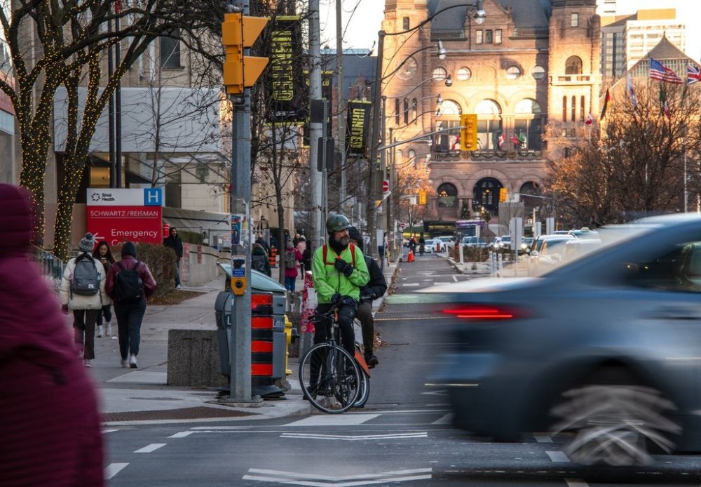 Cyclists ride in a bike lane on University Avenue in Toronto onDecember 13, 2024. THE CANADIAN PRESS/Laura Proctor