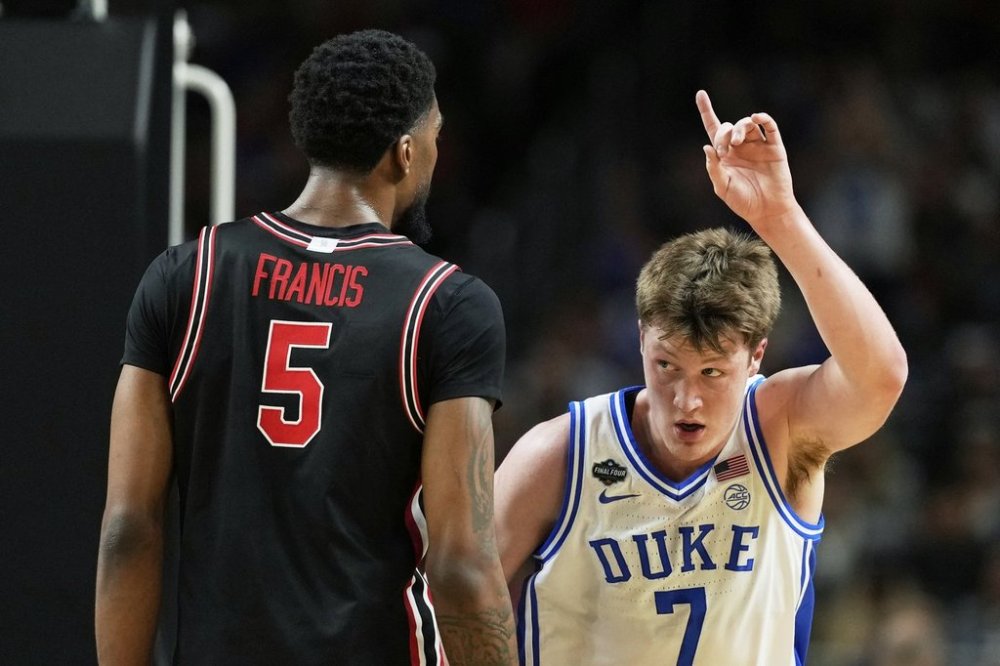 Duke guard Kon Knueppel celebrates after scoring past Houston forward Ja'Vier Francis during the first half in the national semifinals at the Final Four of the NCAA college basketball tournament, Saturday, April 5, 2025, in San Antonio. (AP Photo/Brynn Anderson)