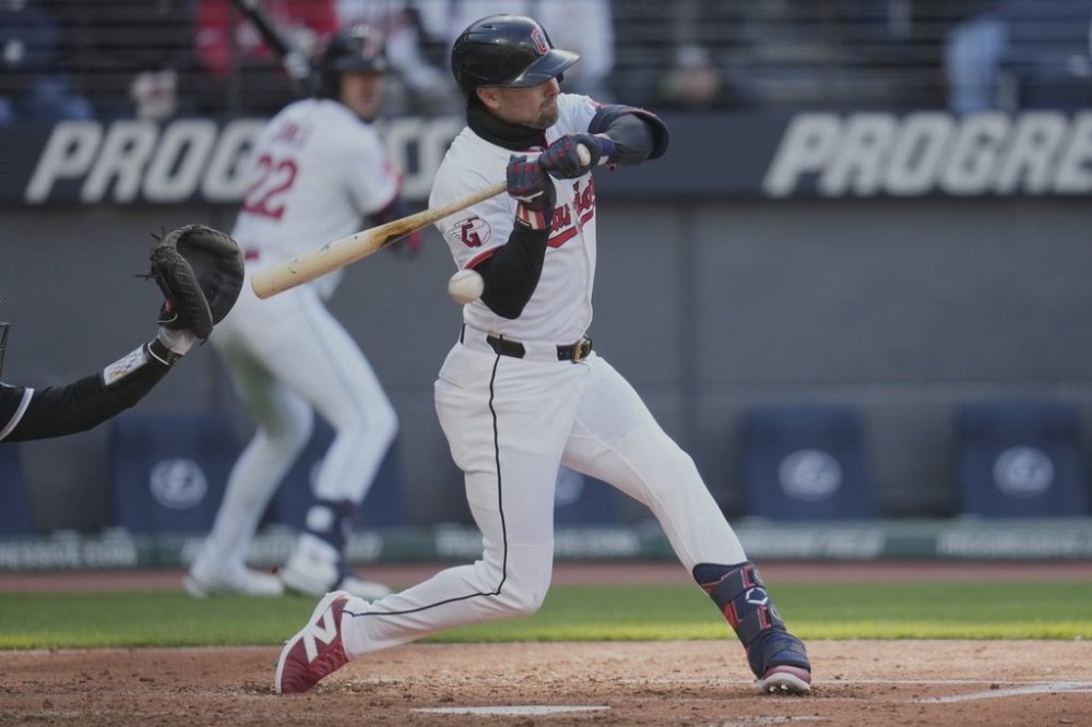 Cleveland Guardians' Lane Thomas is hit by a pitch in the fifth inning of a baseball game against the Chicago White Sox in Cleveland, Tuesday, April 8, 2025. (AP Photo/Sue Ogrocki)