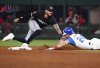 Atlanta Braves' Jarred Kelenic (24) dives into second base against Minnesota Twins shortstop Carlos Correa, left, during the sixth inning of a baseball game Saturday, April 19, 2025, in Atlanta. After a review, Correa was ruled out on the play. (AP Photo/John David Mercer)