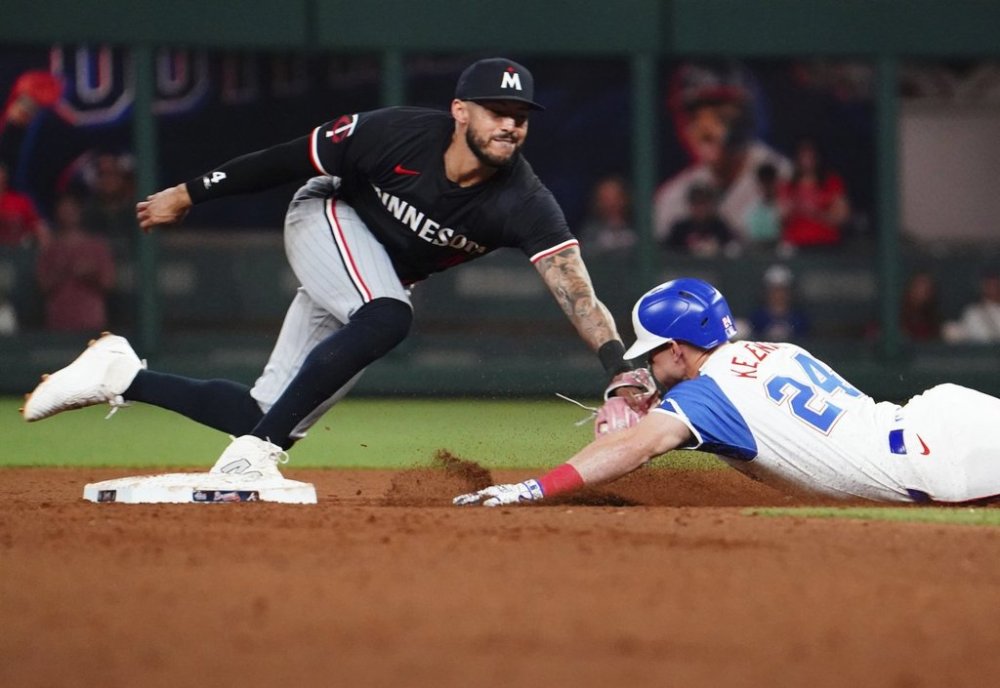Atlanta Braves' Jarred Kelenic (24) dives into second base against Minnesota Twins shortstop Carlos Correa, left, during the sixth inning of a baseball game Saturday, April 19, 2025, in Atlanta. After a review, Correa was ruled out on the play. (AP Photo/John David Mercer)