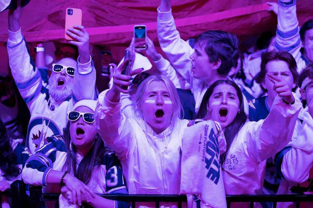 BROOK JONES / FREE PRESS
                                Winnipeg Jets fans Kayla Skoryik (middle) and Aliyah Teixeira (right) cheer during Game 5 of the National Hockey League Stanley Cup playoff between the hometown Winnipeg Jets and the visiting St. Louis Blues as she attends the Winnipeg Jets Whiteout party on Donald Street in Winnipeg. Saturday.