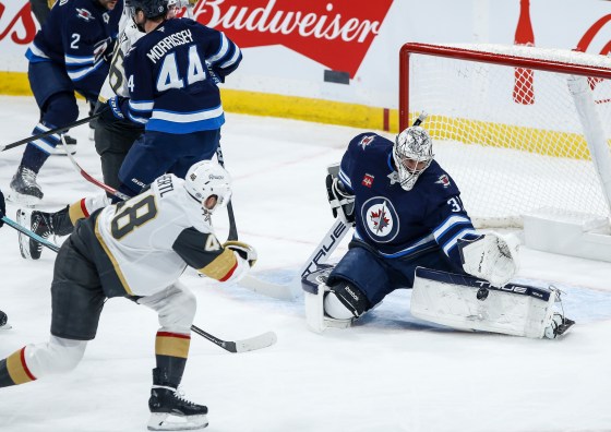 Winnipeg Jets goaltender Connor Hellebuyck (37) saves the backhander from Vegas Golden Knights' Tomas Hertl (48) during the Dec. 12, 2024 game. The Golden Knights won that game 3-2, and they've won their last eight matchups against the Jets. (John Woods / The Canadian Press files)