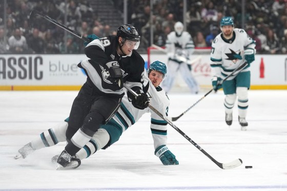 San Jose Sharks defenseman Lucas Carlsson, right, falls as Los Angeles Kings left wing Jeff Malott takes the puck during the third period of Sunday's game in Los Angeles. The Kings won 8-1. (Mark J. Terrill / The Associated Press files)